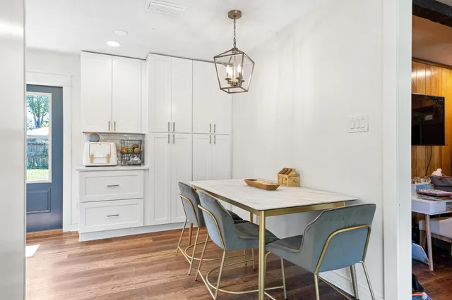 a view of a dining room with furniture and wooden floor