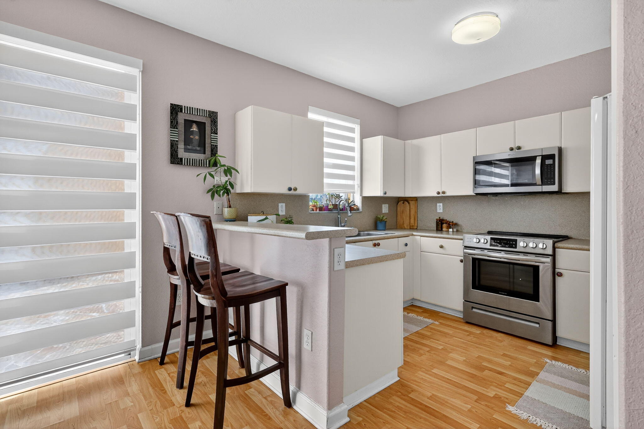 913 Southwest 151 Place Miami, FL 33194 - Photo 17 of 48 a kitchen with stainless steel appliances a stove a sink refrigerator and microwave