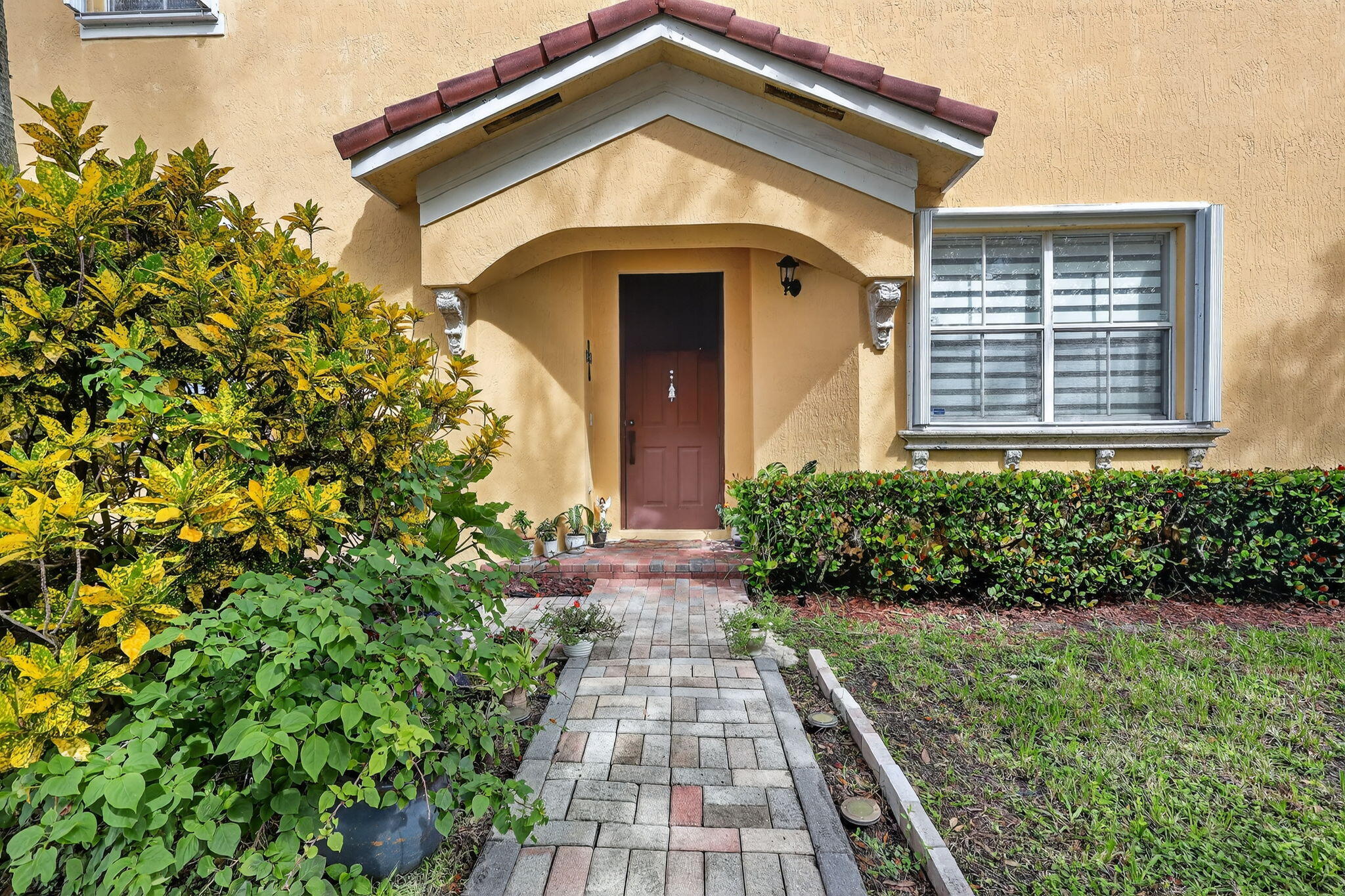 913 Southwest 151 Place Miami, FL 33194 - Photo 4 of 48 a front view of a house with a yard