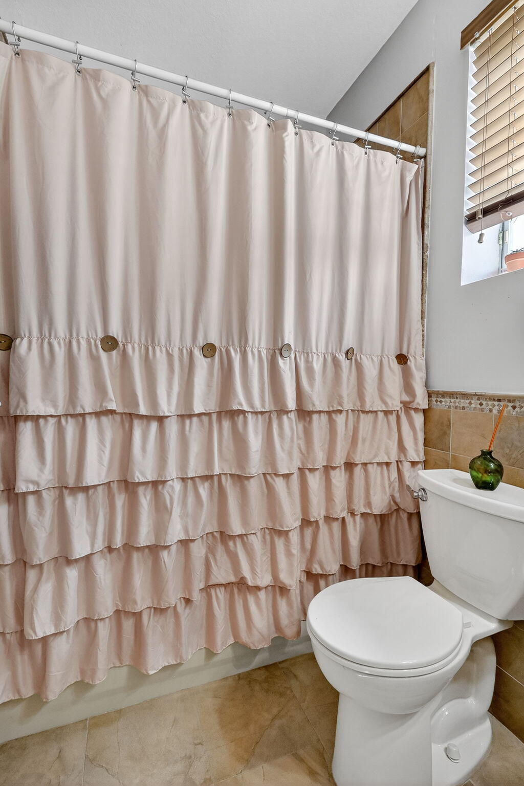 913 Southwest 151 Place Miami, FL 33194 - Photo 46 of 48 a bathroom with a toilet and a shower curtain