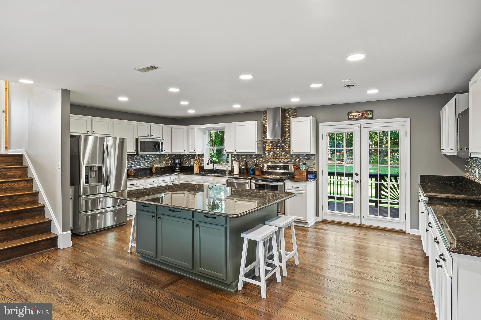 1811 Underwood Road Gambrills, MD 21054 - Photo 18 of 46 a kitchen with stainless steel appliances granite countertop a refrigerator a stove top oven a sink dishwasher and white cabinets with wooden floor