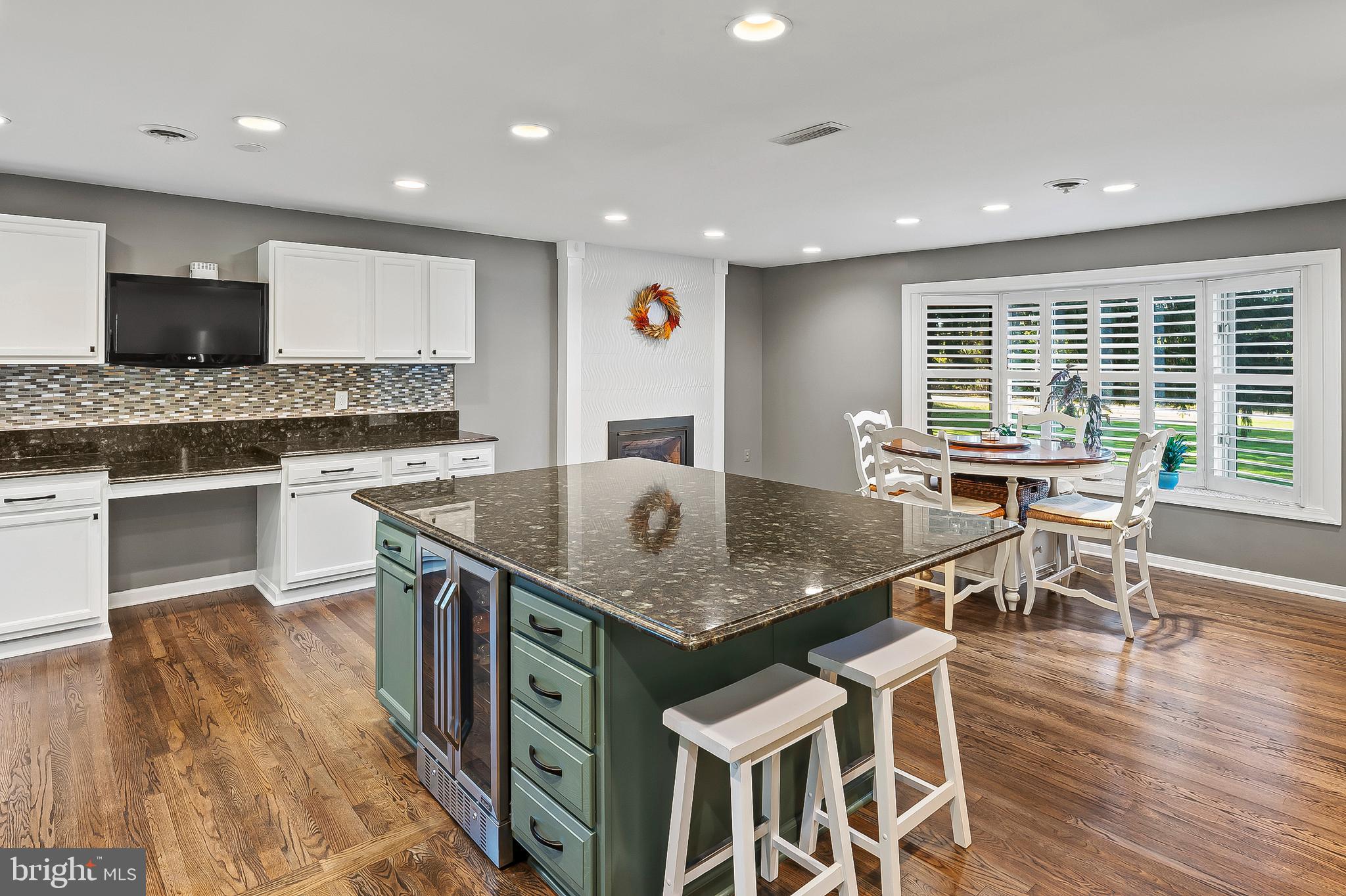 1811 Underwood Road Gambrills, MD 21054 - Photo 20 of 46 a kitchen with stainless steel appliances granite countertop a stove a refrigerator a kitchen island stools a stove a dining table and chairs