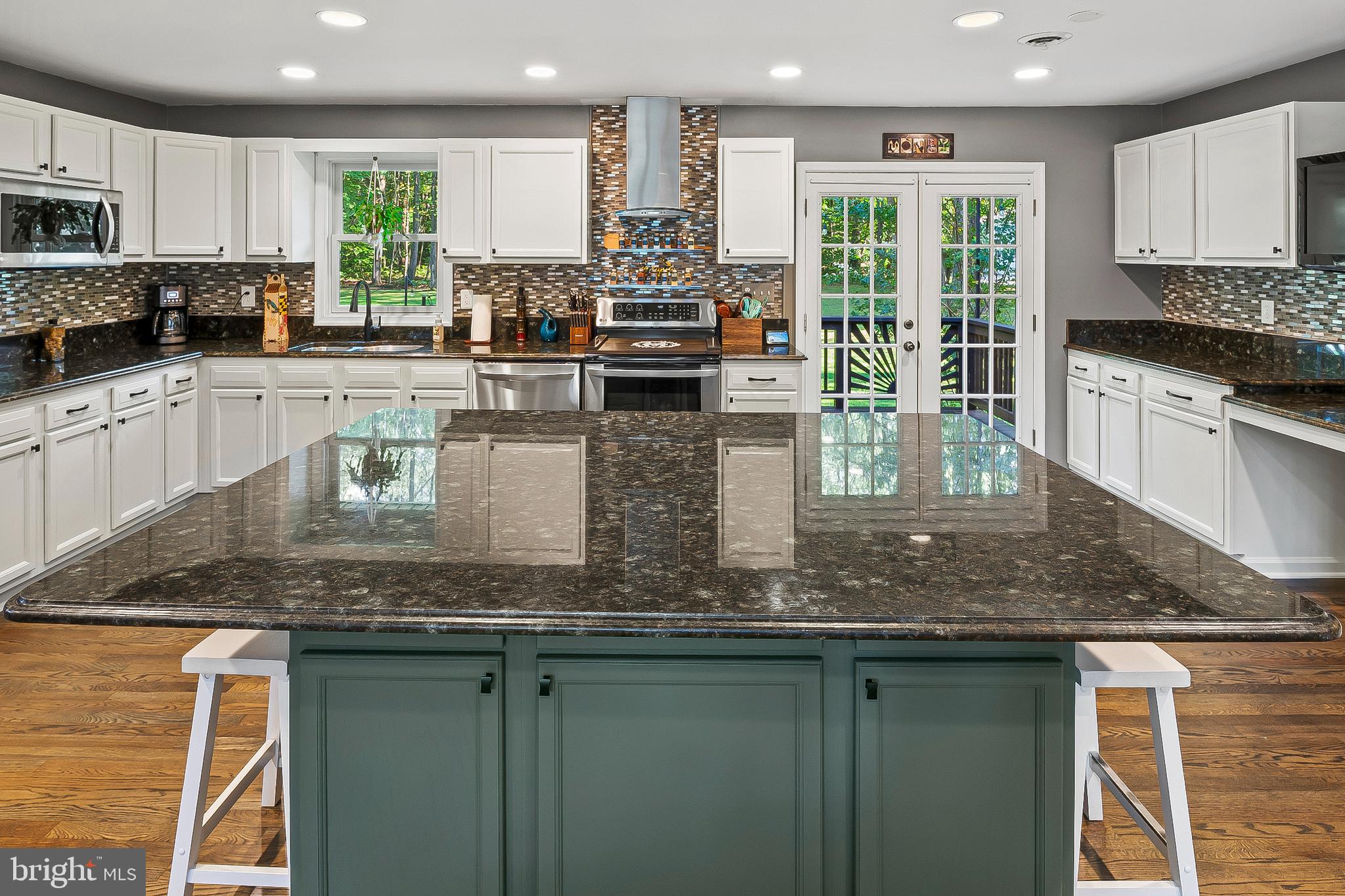 1811 Underwood Road Gambrills, MD 21054 - Photo 24 of 46 a kitchen with stainless steel appliances granite countertop a stove a sink and a microwave