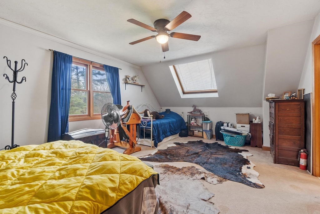 340 Ball Hill Road Princeton, MA 01541 - Photo 40 of 41 a bed room with a bed and a chandelier