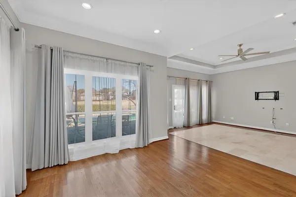 a view of a livingroom with wooden floor and a window