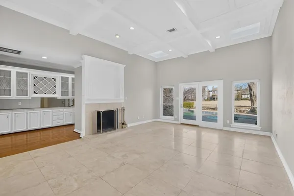 an empty room with furniture and a fireplace