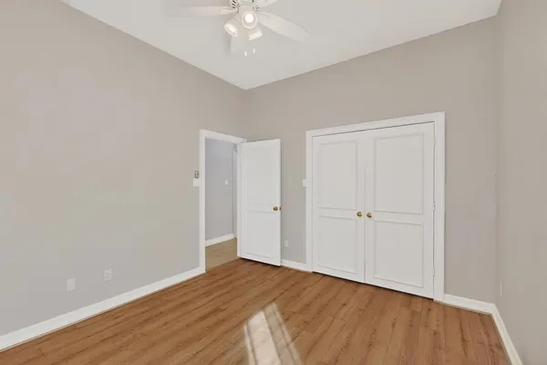 a view of an empty room with wooden floor