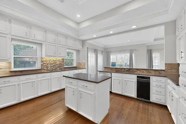 a kitchen with granite countertop white cabinets and white appliances