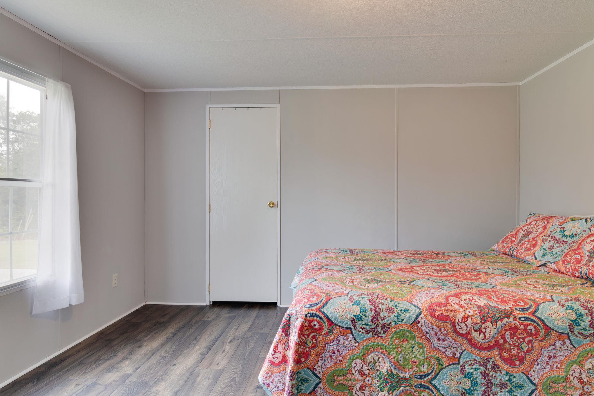 3245 Les Chappell Road Spring Hill, TN 37174 - Photo 14 of 22 a bedroom with a bed and a window with wooden floor