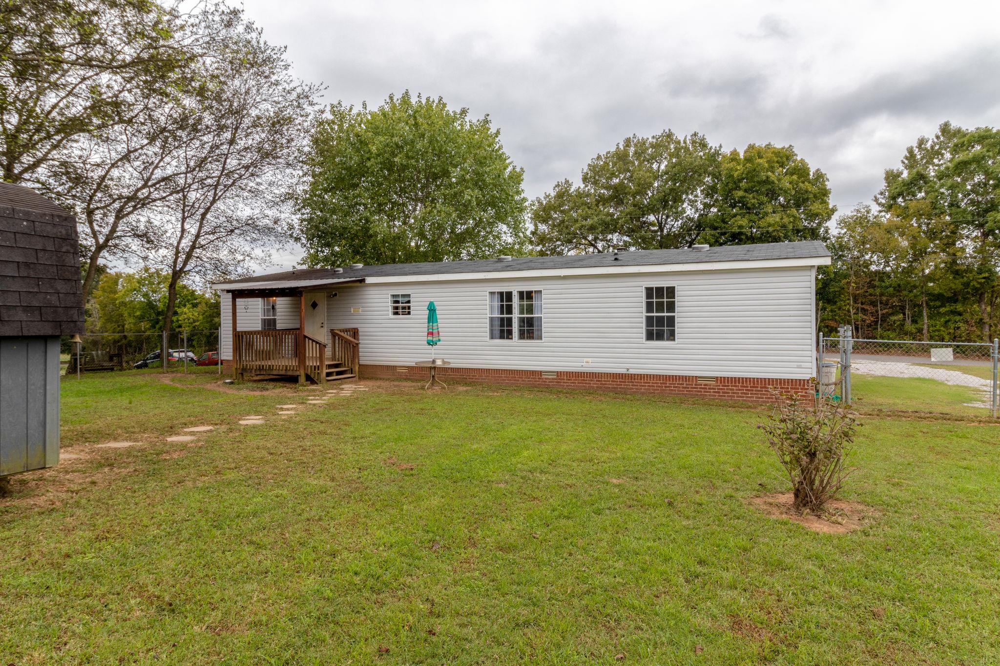 3245 Les Chappell Road Spring Hill, TN 37174 - Photo 18 of 22 a view of a yard in front of a house with a large tree
