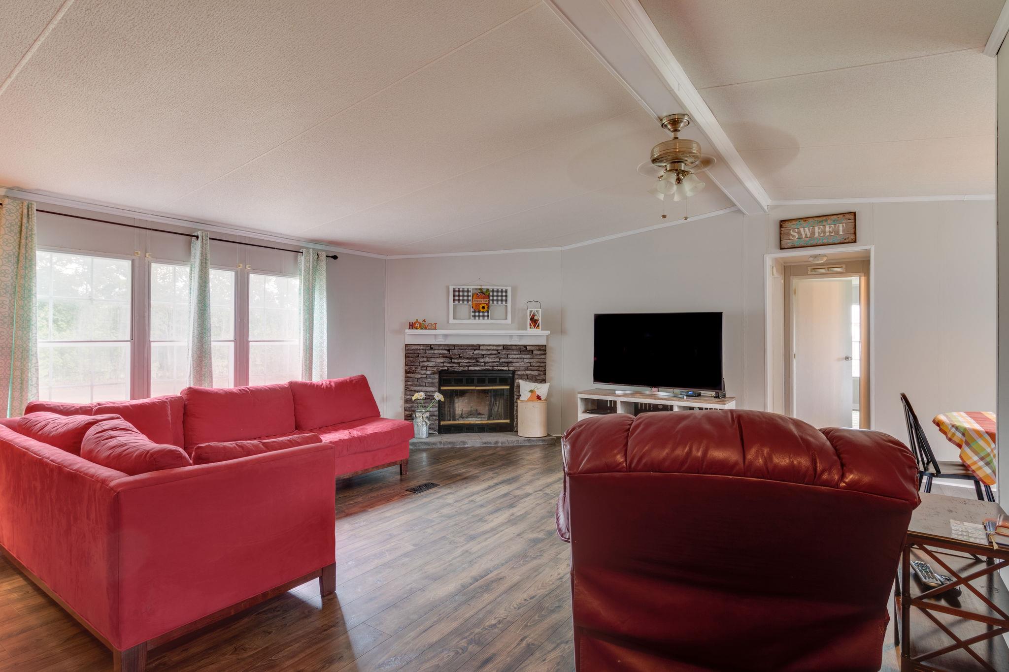 3245 Les Chappell Road Spring Hill, TN 37174 - Photo 2 of 22 a living room with furniture a flat screen tv and a large window