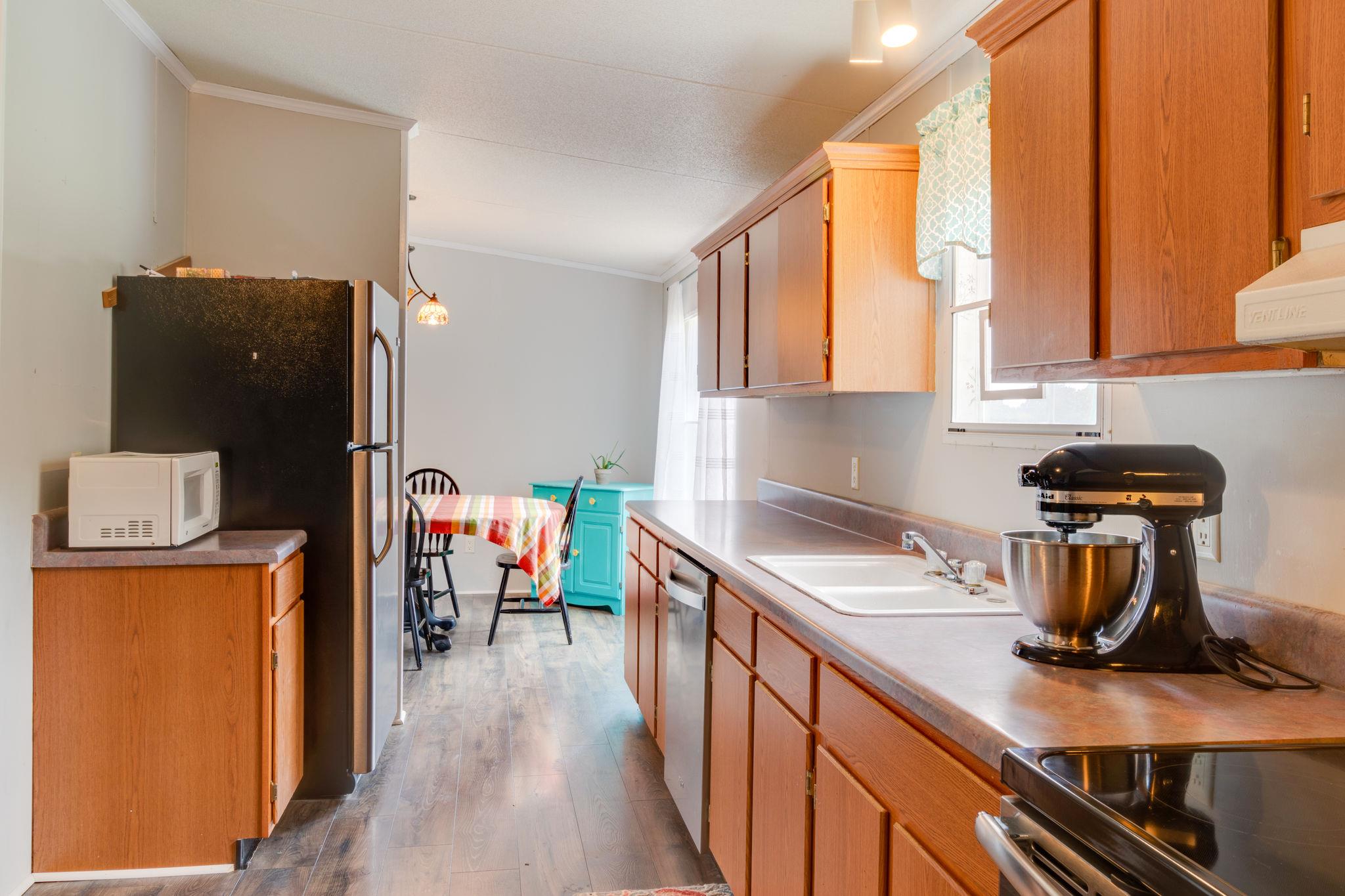 3245 Les Chappell Road Spring Hill, TN 37174 - Photo 9 of 22 a kitchen with a refrigerator and a stove top oven