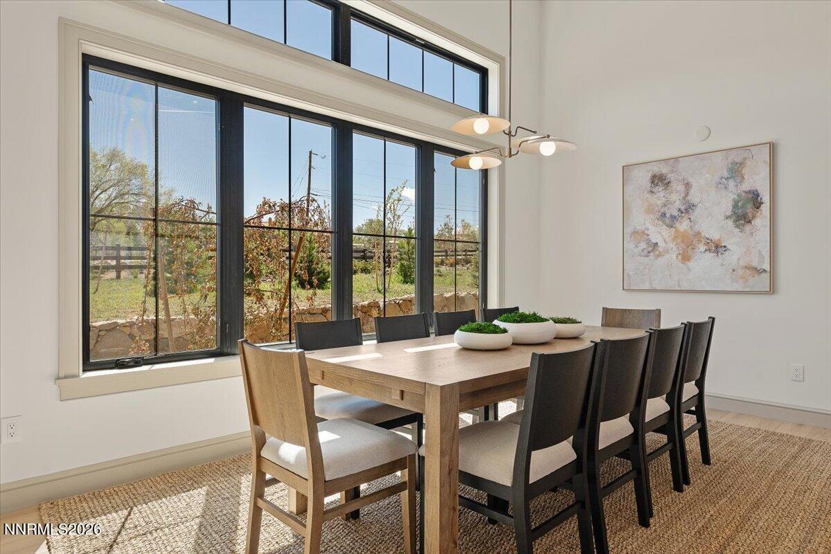 11 Glenhaven Drive Reno, NV 89511 - Photo 14 of 51 a view of a dining room with furniture large window and wooden floor