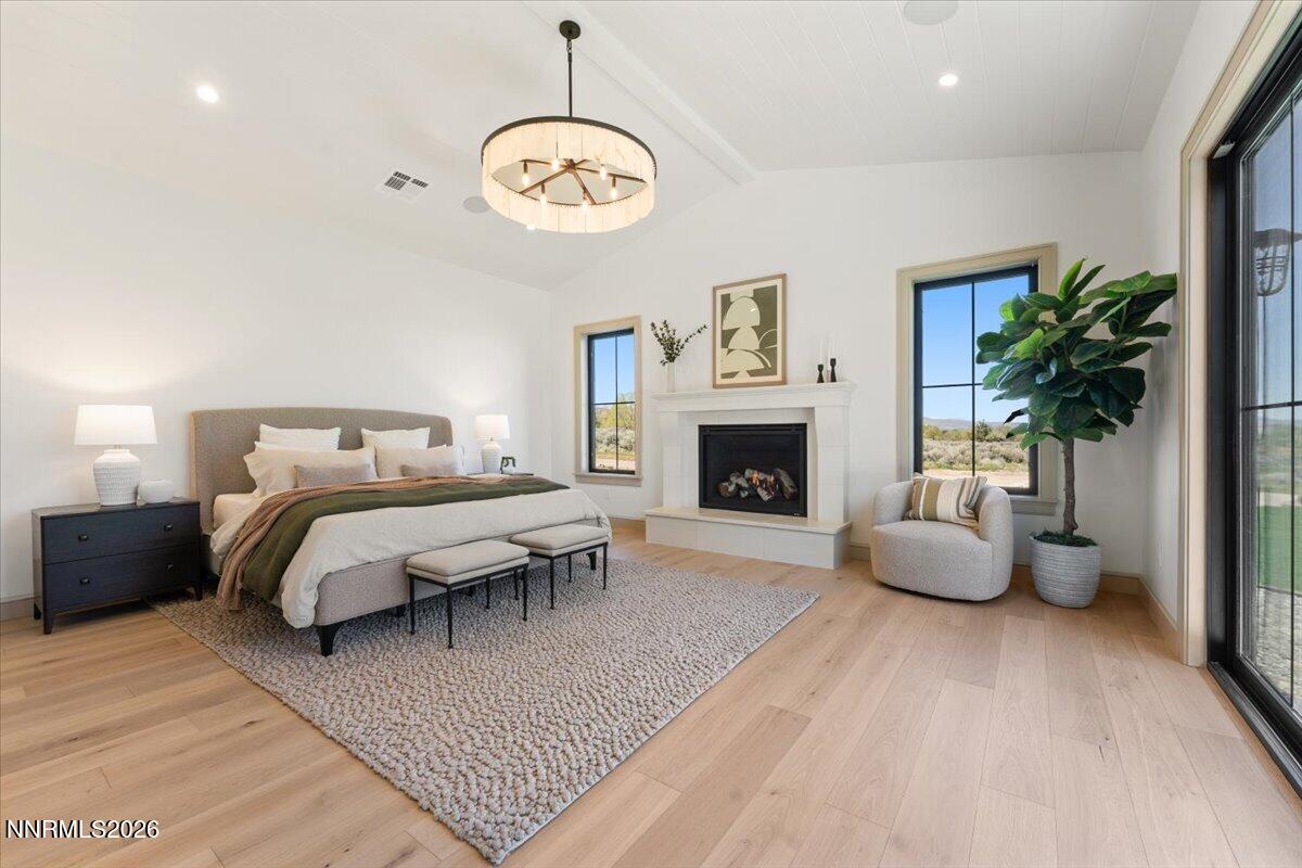 11 Glenhaven Drive Reno, NV 89511 - Photo 23 of 51 a spacious bedroom with a bed and a fireplace