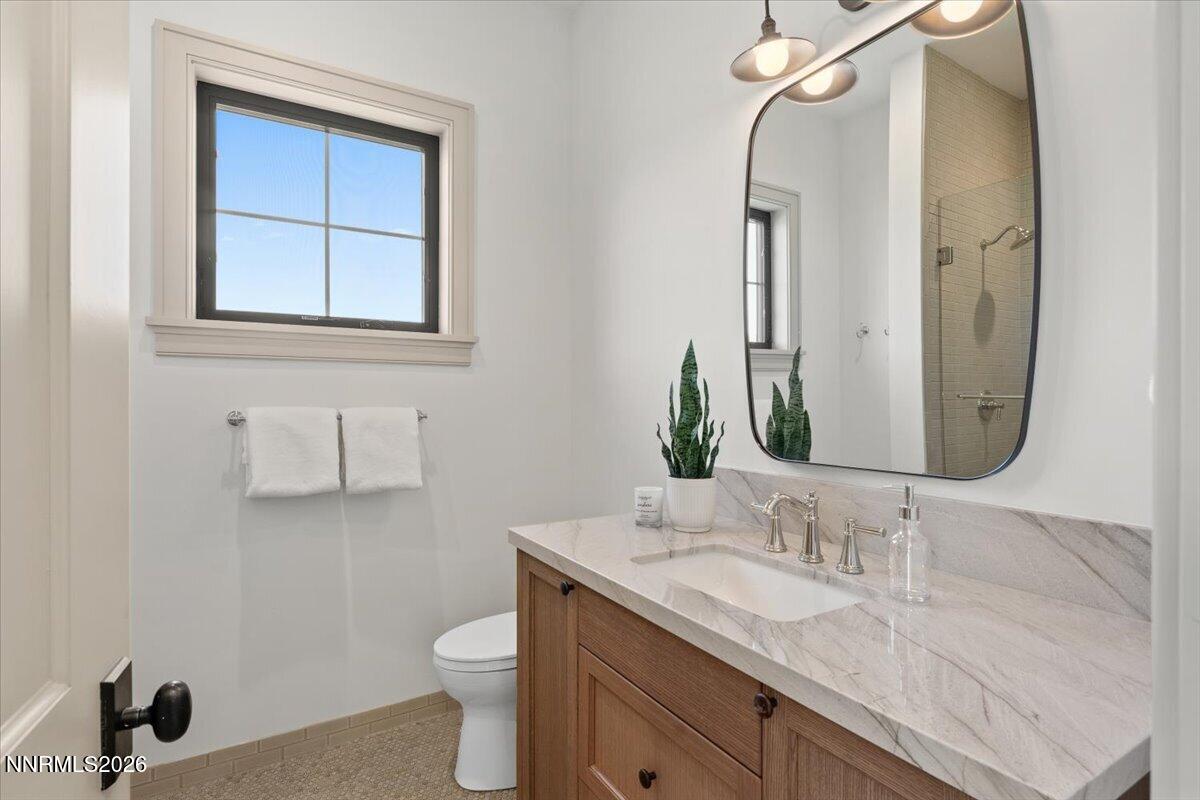 11 Glenhaven Drive Reno, NV 89511 - Photo 37 of 51 a bathroom with a granite countertop sink toilet and mirror