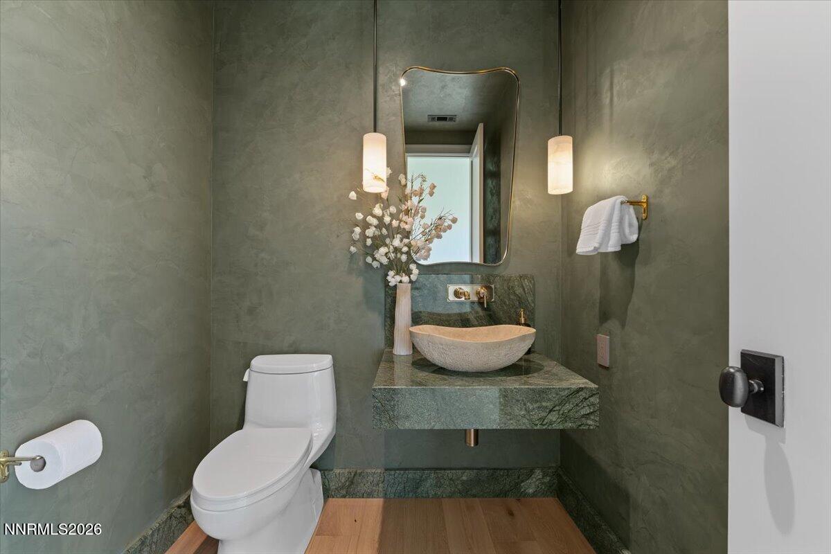 11 Glenhaven Drive Reno, NV 89511 - Photo 40 of 51 a bathroom with a toilet sink and mirror