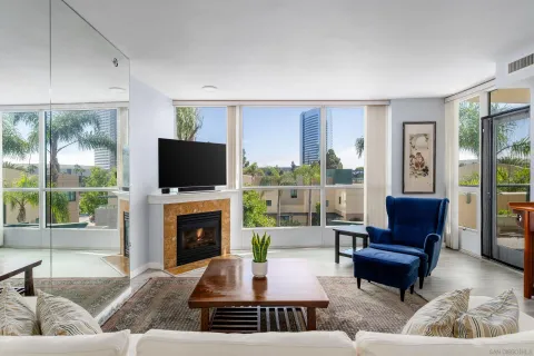 a living room with furniture a flat screen tv and a fireplace