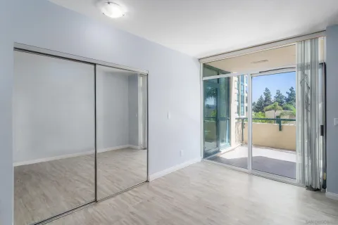 a bedroom with a bed and large window