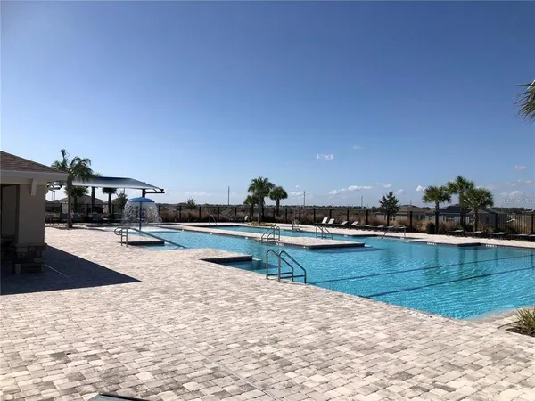 a view of a swimming pool and an outdoor seating