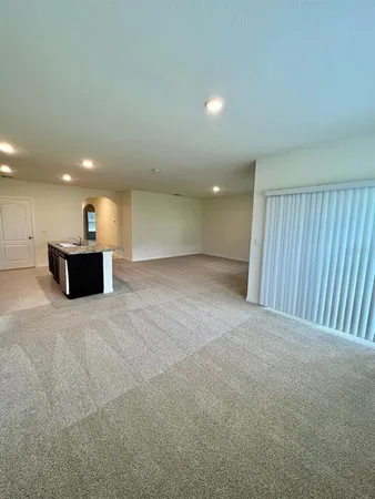 a view of a big room with wooden cabinet and windows