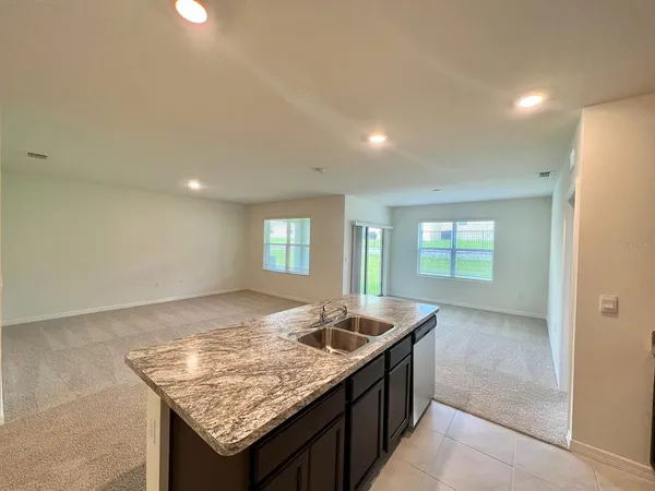 a view of kitchen island sink and living room