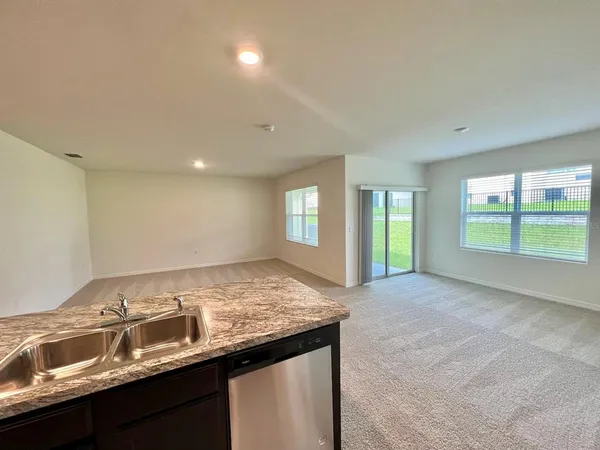 a view of a kitchen with granite countertop sink and a granite counter tops