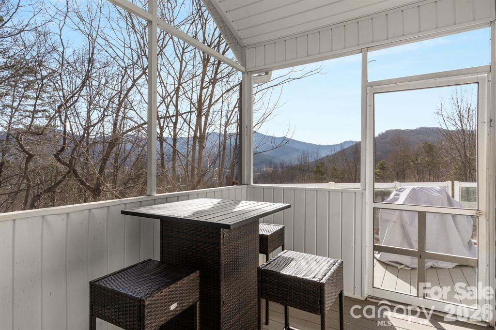 56 Great Horned Owl Road Candler, NC 28715 - Photo 18 of 32 a view of a balcony with a table and chairs