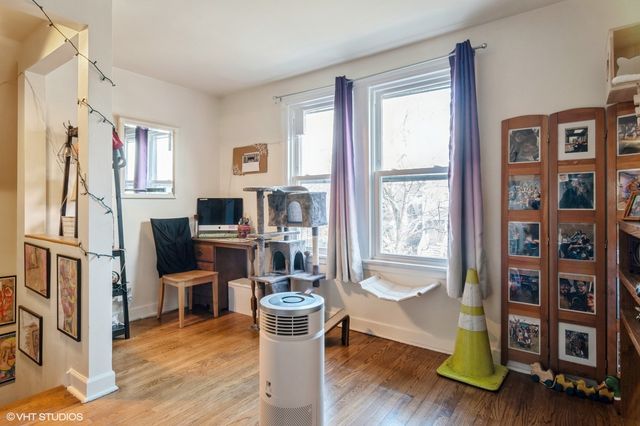 a living room with furniture window and wooden floor