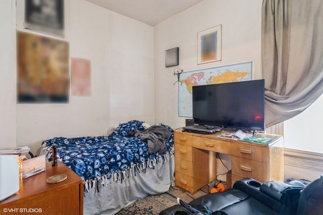 a bedroom with bed and tv