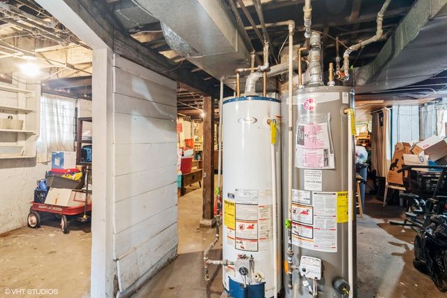 a utility room with dryer and refrigerator