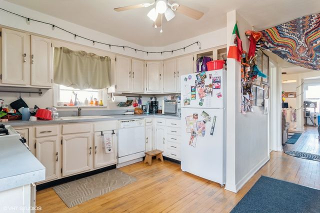 a kitchen with white cabinets and white appliances