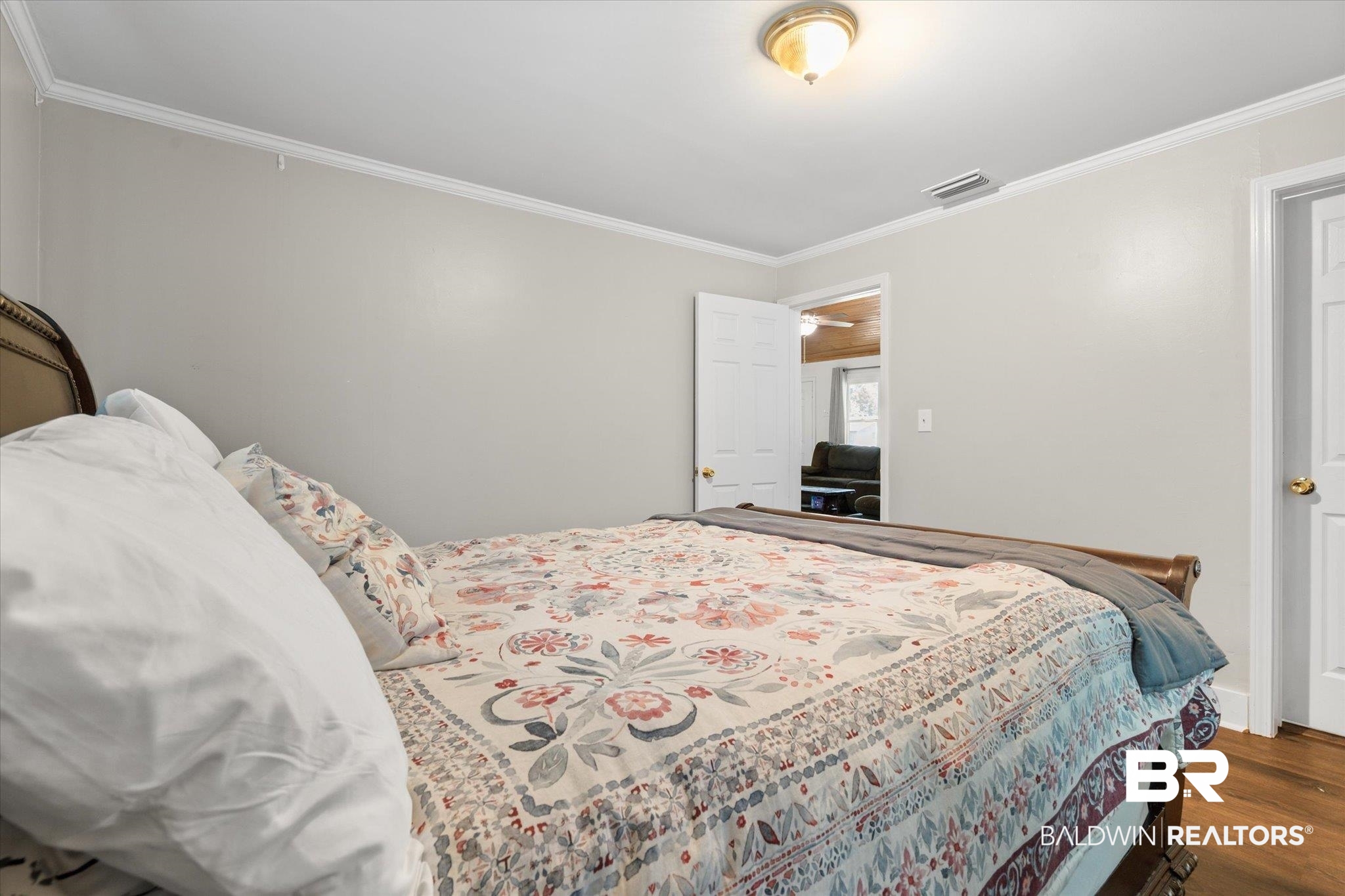529 Cleveland Road Saraland, AL 36571 - Photo 18 of 31 Bedroom with crown molding, wood finished floors, and visible vents