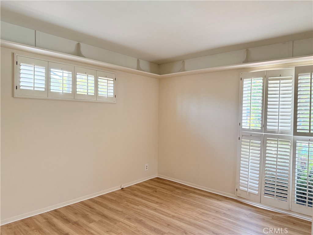11682 Harrisburg Road Los Alamitos, CA 90720 - Photo 11 of 23 an empty room with wooden floor and windows
