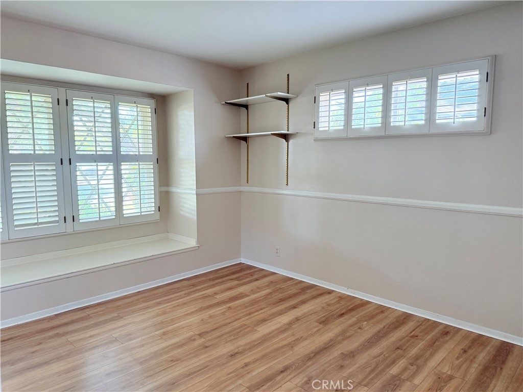 11682 Harrisburg Road Los Alamitos, CA 90720 - Photo 12 of 23 an empty room with wooden floor and windows