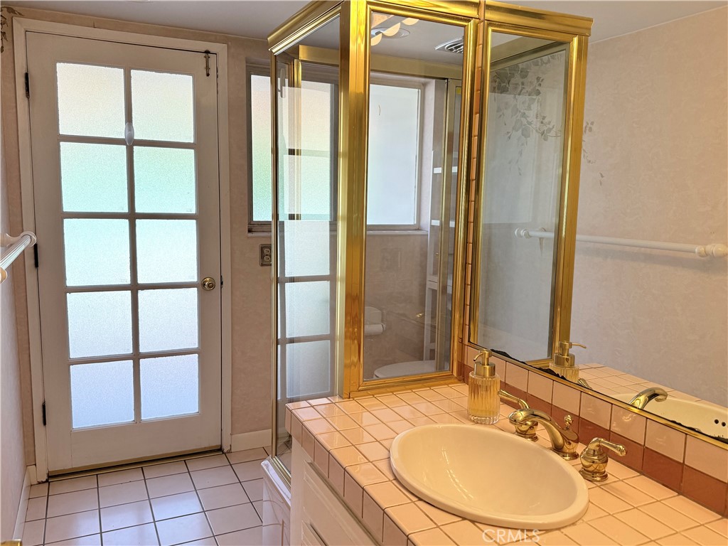 11682 Harrisburg Road Los Alamitos, CA 90720 - Photo 13 of 23 a bathroom with a sink toilet and shower