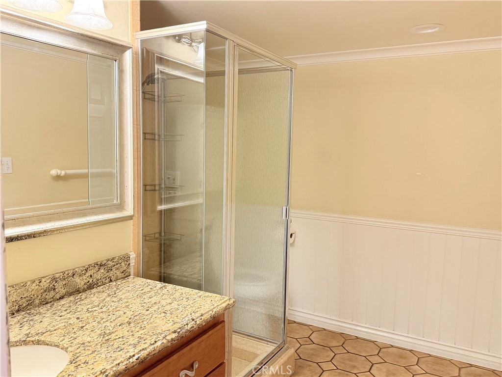 11682 Harrisburg Road Los Alamitos, CA 90720 - Photo 14 of 23 a bathroom with a granite countertop shower and a sink