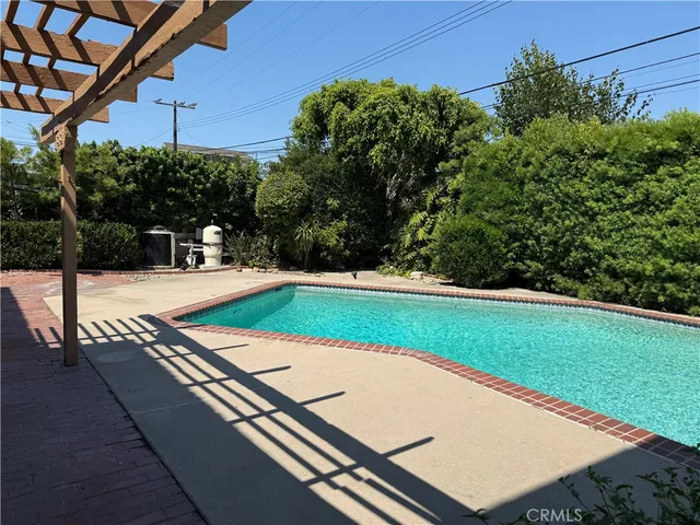 a view of a swimming pool with a patio