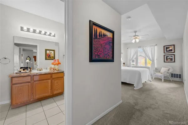 a spacious en suite bathroom with a sink and a mirror