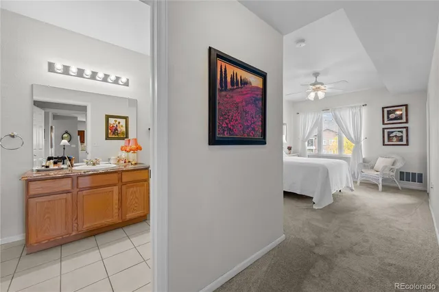 a spacious en suite bathroom with a sink and a mirror