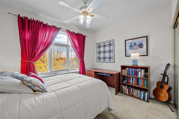 a bedroom with a bed furniture and a large window