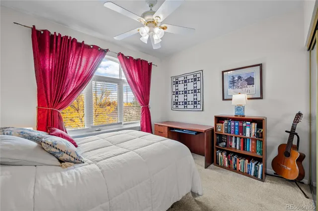 a bedroom with a bed furniture and a large window