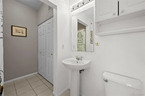 a bathroom with a sink mirror and toilet