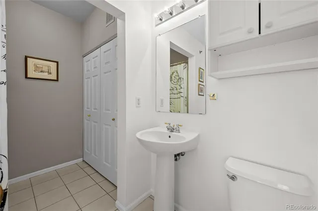 a bathroom with a sink mirror and toilet