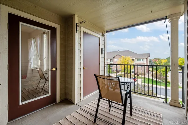 a view of a balcony with furniture and wooden floor