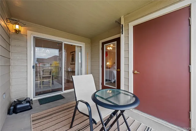 a view of a room that has a table and a chair with wooden floor