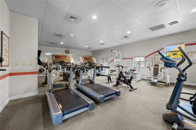 a room with gym equipment and windows