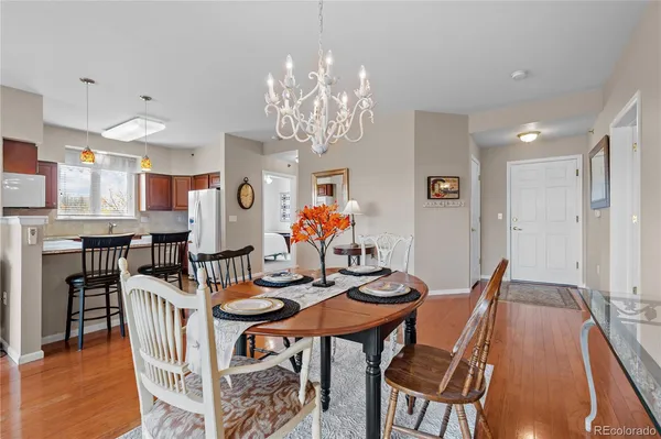 a view of a dining room with furniture wooden floor and chandelier