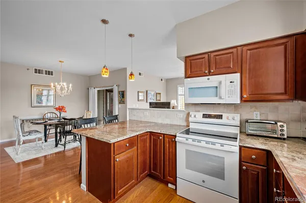 a kitchen with stainless steel appliances granite countertop a stove and a sink