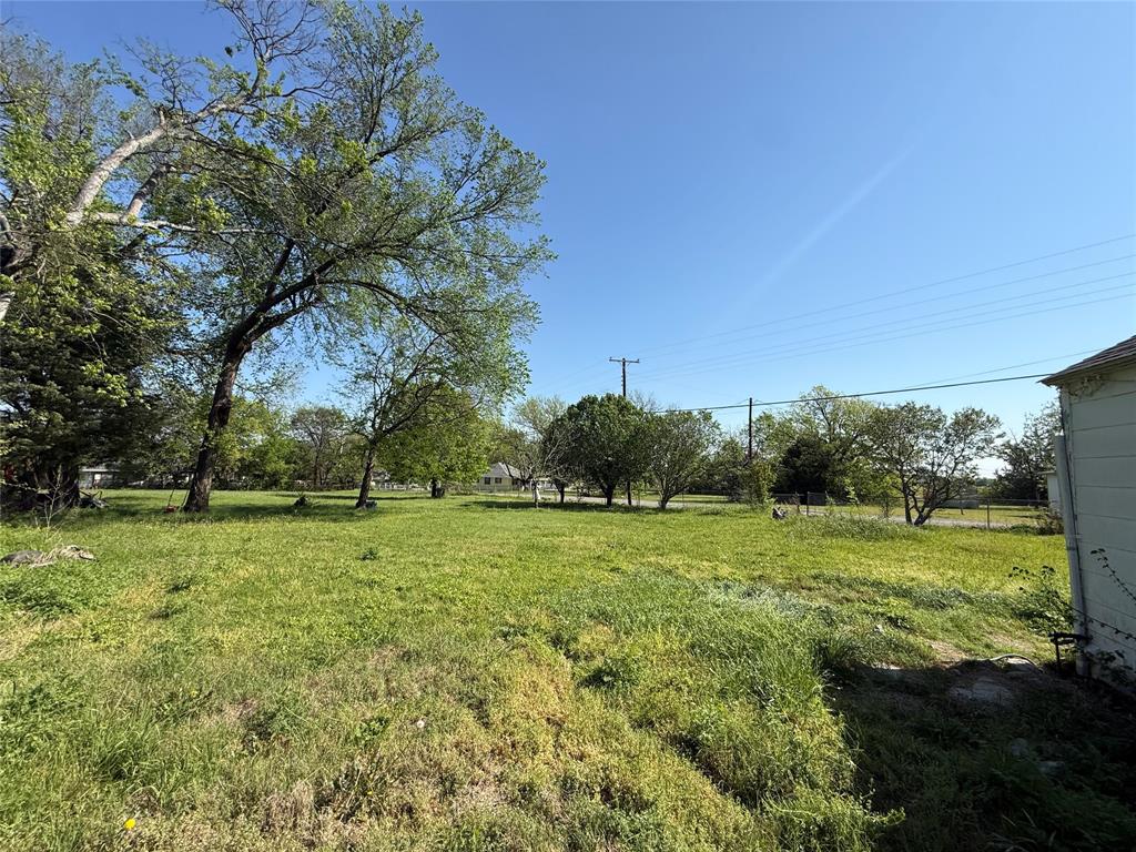 243 Walnut Street Wilmer, TX 75172 - Photo 14 of 20 a big yard with lots of green space and trees