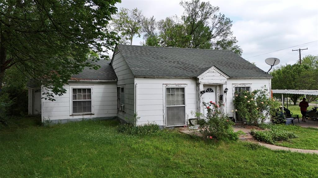 243 Walnut Street Wilmer, TX 75172 - Photo 6 of 20 a view of a house with a yard and a garden